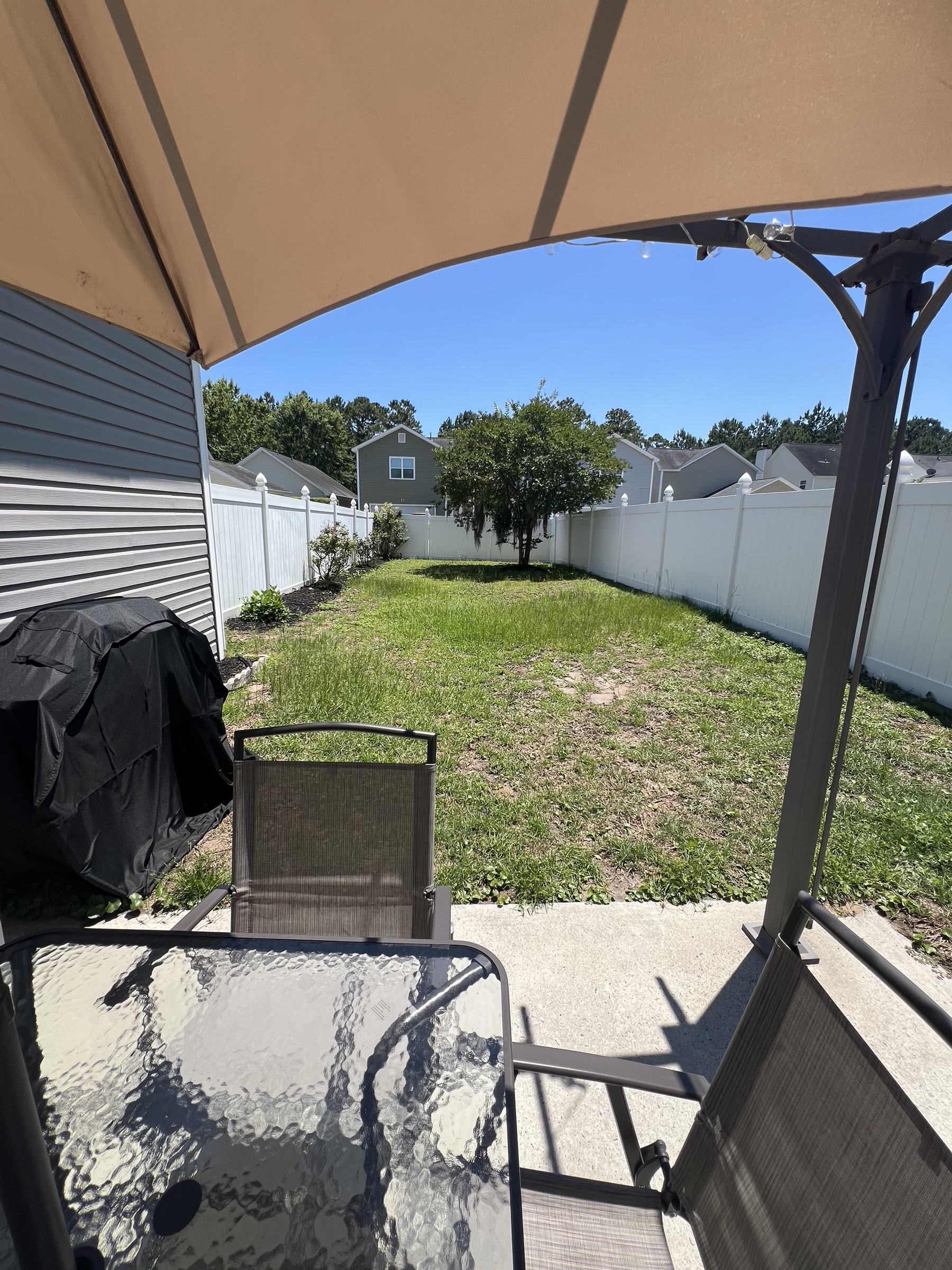 Fenced backyard with patio seating